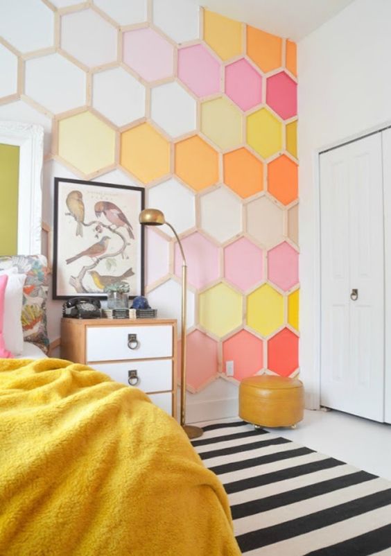 a bright hexagon wall mural brings a lot of color to the bedroom making it cheerful and fun and you can choose items to match it