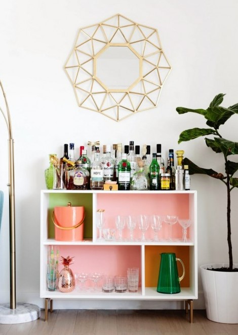 a bright home bar made of an IKEA Valje shelf with colored contact paper to spruce up the inside of each compartment