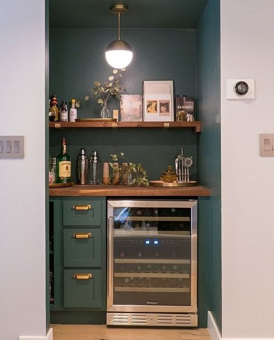 a built-in home bar with an open shelf, drawers and a fridge plus some greenery is a chic idea