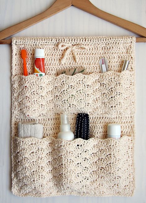 a cool crocheted bathroom organizer is a cool idea - such pockets can be DIYed to organize your bathroom a bit