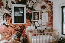 a cute nursery with a bold floral wall mural that gives a tender and romantic feel to the space