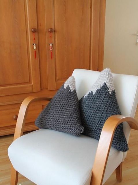 a lovely triangular mountain-inspired crocheted pillow is a pretty idea for your space, it may add interest and a hygge feel to it