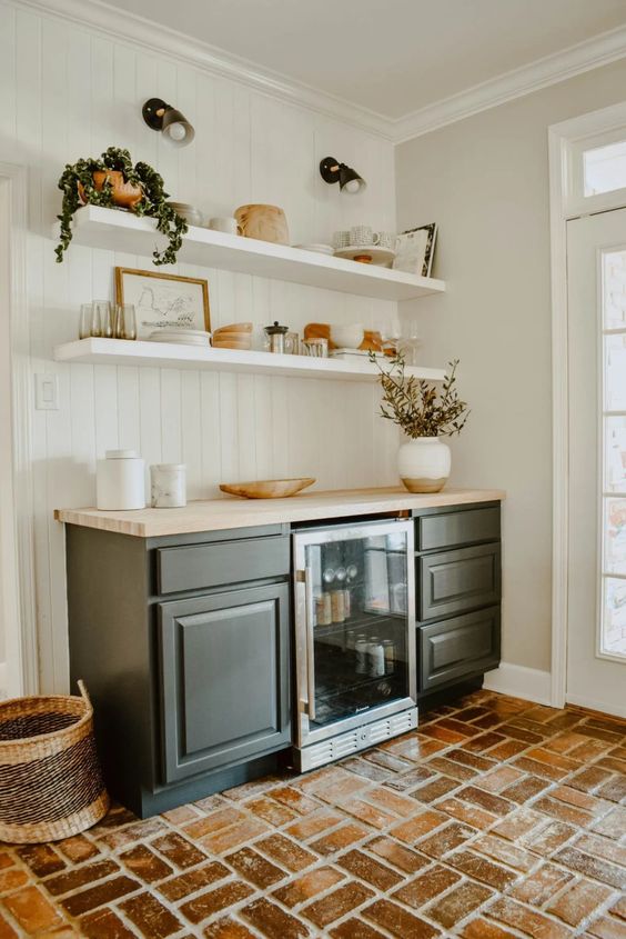 a mid-century modern with open shelves, black cabinetry, potted greenery and various decor and a wine cooler is a lovely idea for a farmhouse space
