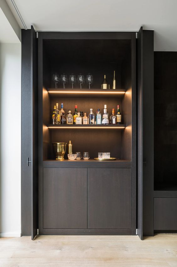 a minimalist dark-stained home bar with open shelves with built-in lights, a cabinet is a lovely idea for a refined and luxurious space