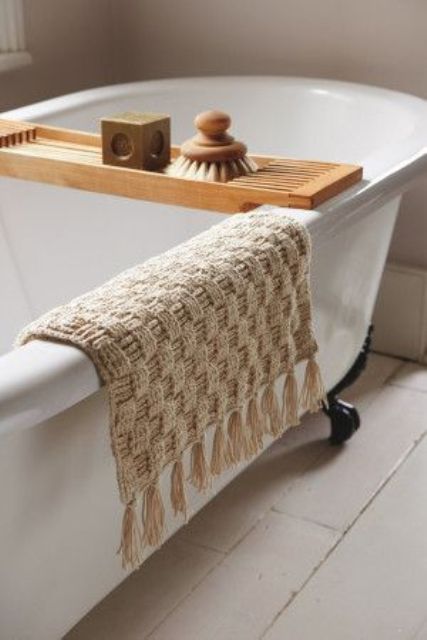 a neutral woven crochet rug with tassels will be a great addition to your bathroom and will add it a spa feel easily