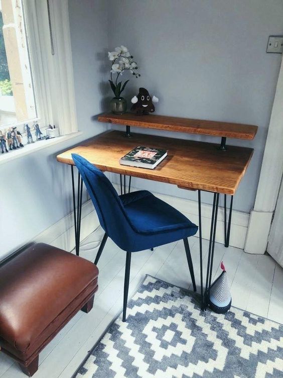 a pretty small industrial desk of wood and metal, with hairpin legs and a blue chair for working with comfort
