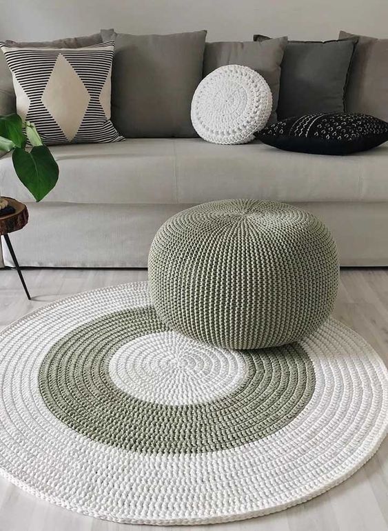 a pretty white and green crocheted rug and a matching green pouf will add chic and interest to your modern or Scandi space