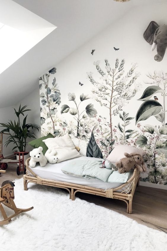 a romantic kid's space with a beautiful botanical wall mural and potted plants that match it