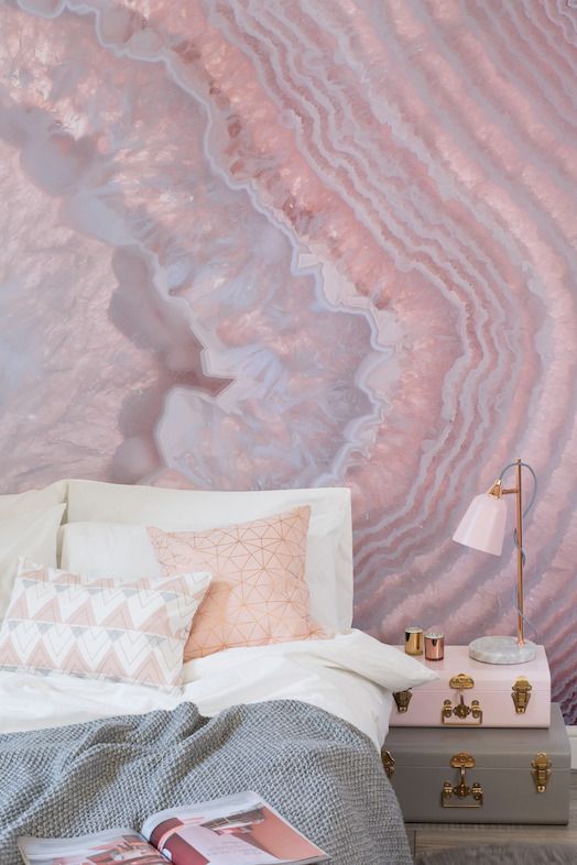a sweet pink geode wall mural and echoing pillows and a lamp make the bedroom cute and girlish, geodes bring an edgy touch