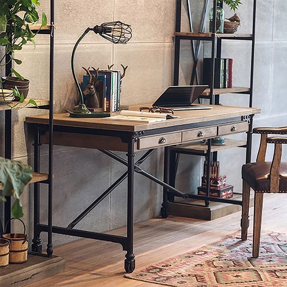 a vintage industrial home office with shelving units of wood and metal pipes, a matching elegant desk of pipes and wood, with casters and drawers
