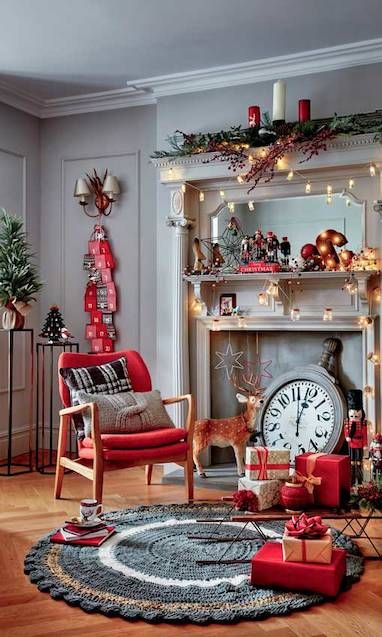 a whimsical Christmas space in red and grey, with pillar candles, lights, an advent calendar, gift boxes, an oversized watch and evergreens