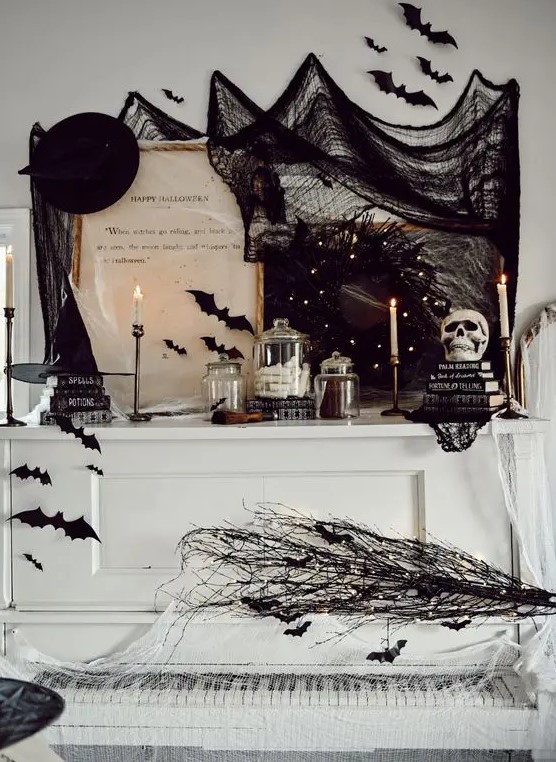 a white piano decorated with black branches and bats, lights, black spider web, hats, bats, candles and other stuff looks amazing