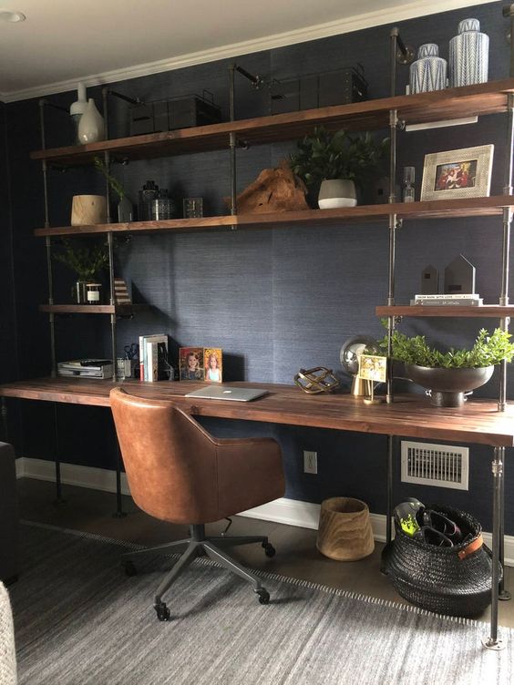 an oversized open storage unit with a built-in industrial desk of metal pipes and wood is a whole very practical working station