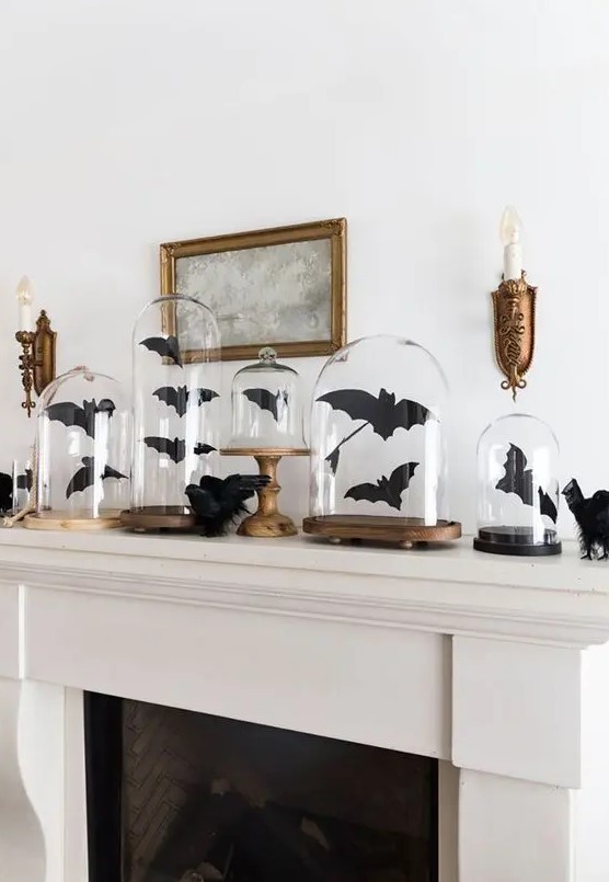 black paper bats in cloches and on the mantel are great to style it for Halloween, and they are easy to craft