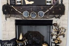 glam black and gold Halloween decor – an artwork with gold bats, a gold garland, gold candles, pumpkins and black mesh