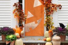 natural pumpkins, spray painted or not, fall leaves and a front door styled as a jack-o-lantern for a bright Halloween porch