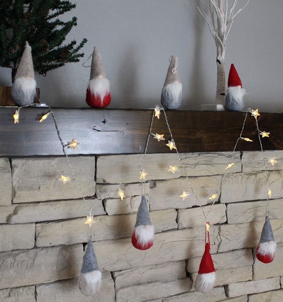 pretty Christmas decor - red and grey gnomes n hats, a star-shaped light garland are all you need for a cool Christmas mantel
