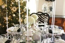 a black tablecloth, crystal garlands, faux fur placemats, black balloons and silver ornaments