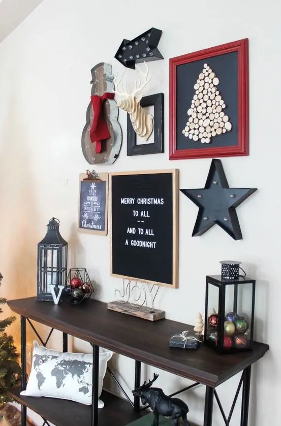 a bold industrial Christmas gallery wall with marquees, signs, artworks, a cardboard deer head and chalkboards