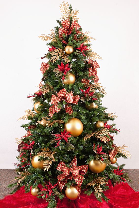 a bold red and gold Christmas tree with bows, gilded foliage, large gold ornaments