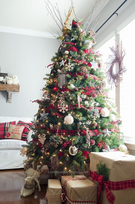 a bright Christmas tree decorated with plaid ribbons and ornaments, lights, snowflakes, deer and twigs is very cool