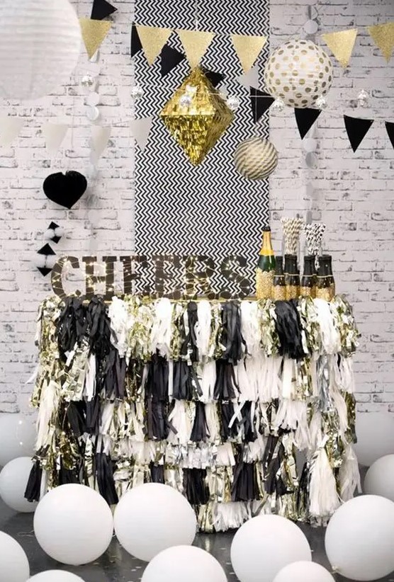 a cheerful black and silver sparkly fringe bar cart with a sign and lights and balloons around