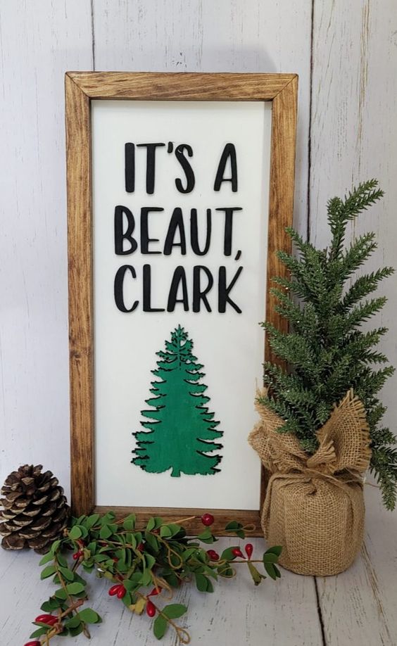 a cool Christmas sign with letters, a green tree and a stained wooden frame is a cool farmhouse or rustic decor idea