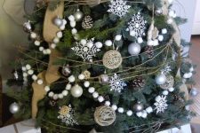 a farmhouse Christmas tree with snowball garlands, burlap ribbons, pinecones, greenery and silver ornaments is a lovely idea