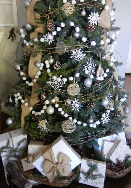 a farmhouse Christmas tree with snowball garlands, burlap ribbons, pinecones, greenery and silver ornaments is a lovely idea