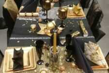 a fun black and gold tablescape with stars, stripes and candles is amazing for a New Year’s Eve