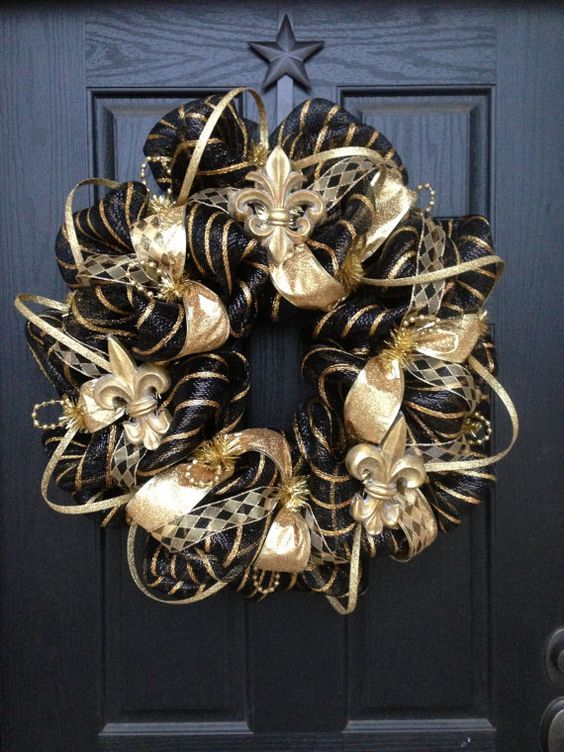 a glam vintage Christmas wreath in black and gold, with ribbons and beads is amazingly lovely