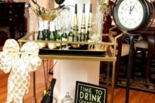 a gold and black bar cart with balloons, a polka dot bow and polka dot paper is a great idea for a NYE party
