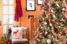 a large Christmas tree decorated with red and white ornaments and plaid ribbons is a bold and traditional idea for the holidays