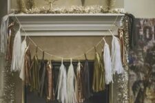 a metallic tassel garland over the fireplace and tinsel garlands are amazing for NYE parties