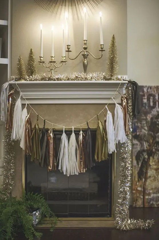 a metallic tassel garland over the fireplace and tinsel garlands are amazing for NYE parties
