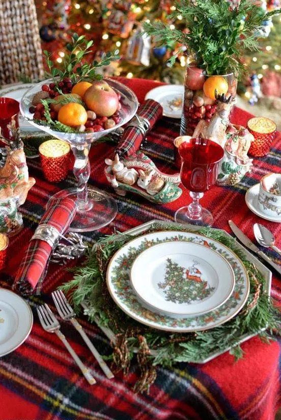 a plaid tablecloth and napkins add a cozy traditional feel to the table, and evergreens make it lively