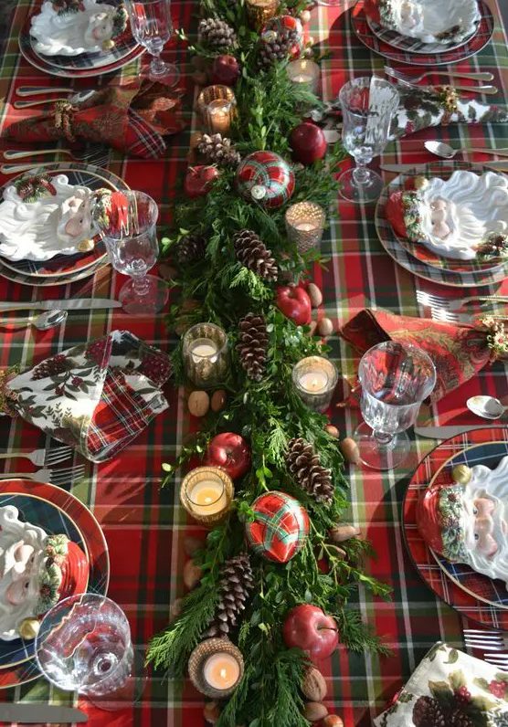 a plaid tablecloth, plaid napkins and plates and even plaid ornaments refreshed with evergreens