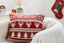 a red and white Scandinavian pattern pillow like this one is a cool idea for holiday decor, and you can buy or make it yourself