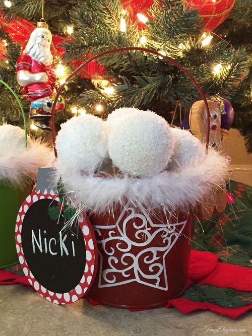 a red snowflake bucket with fluffy snowballs and a sign is a lovely decoration for Christmas and it looks very fun