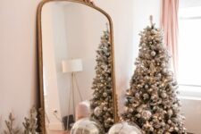 a silver Christmas tree fully decorated with silver disco balls is a super cool and fresh decor idea for a NYE party