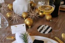 a sparkly tablescape with glitter ornaments, tulips, evergreens and black and white touches