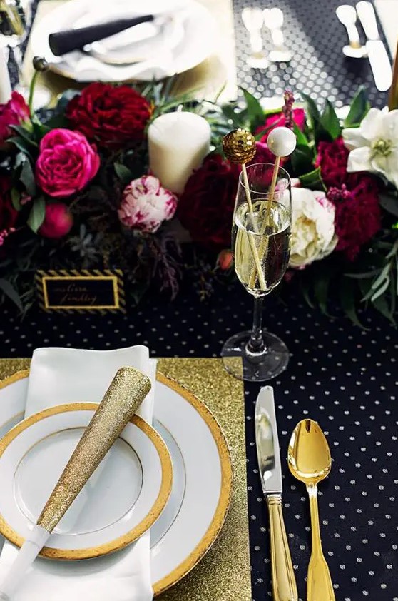 a tablescape with a lush floral garland, gold glitter touches, a polka dot tablescape and sparkly drink stirrers