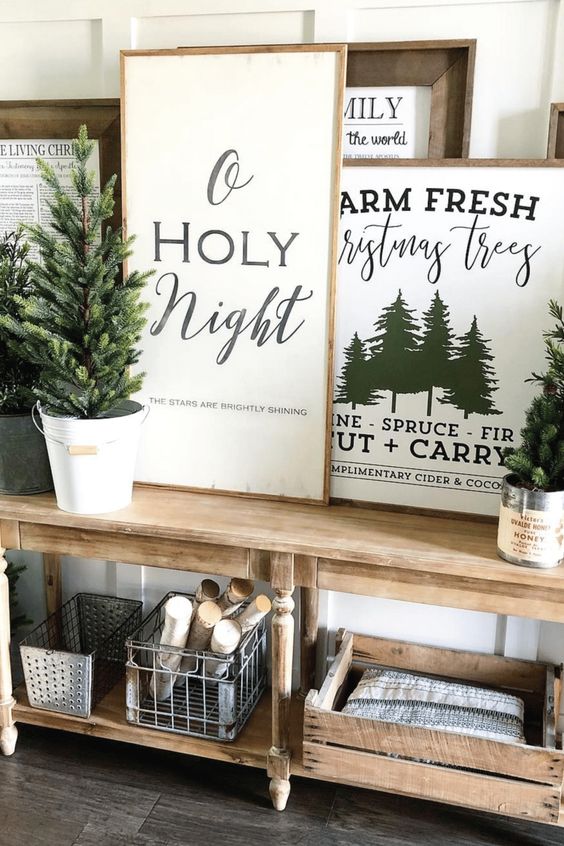 a whole arrangement of Christmas signs and prints in stained wooden frames is a lovely idea for a rustic space