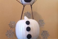 an Olaf snowman of pumpkins painted, with silver snowflakes around and some branches is a cool Disney themed decor idea