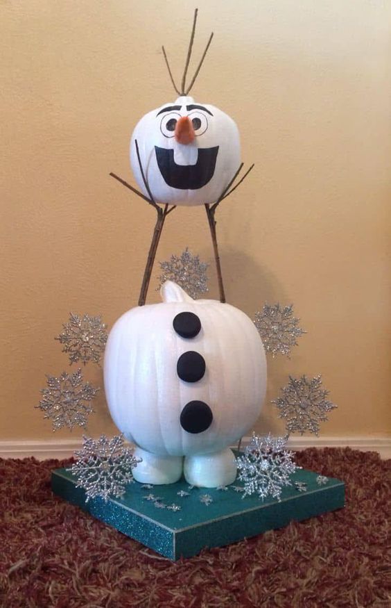 an Olaf snowman of pumpkins painted, with silver snowflakes around and some branches is a cool Disney themed decor idea