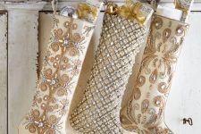 beautiful sophisticated neutral embellished Christmas stockings with ornamnes and gifts are amazing to style your refined space for Christmas