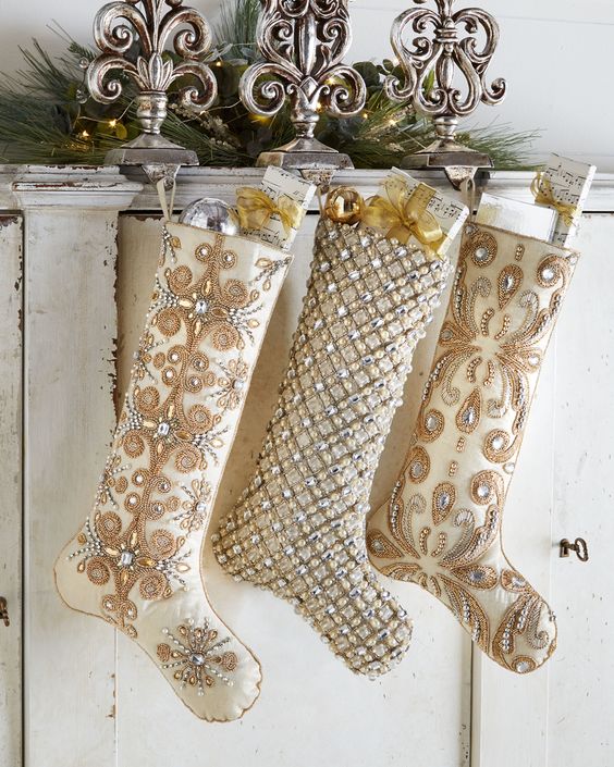 beautiful sophisticated neutral embellished Christmas stockings with ornamnes and gifts are amazing to style your refined space for Christmas