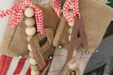 burlap stockings with wooden beads and monograms, plaid bows and vintage note paper are amazing for vintage Christmas spaces