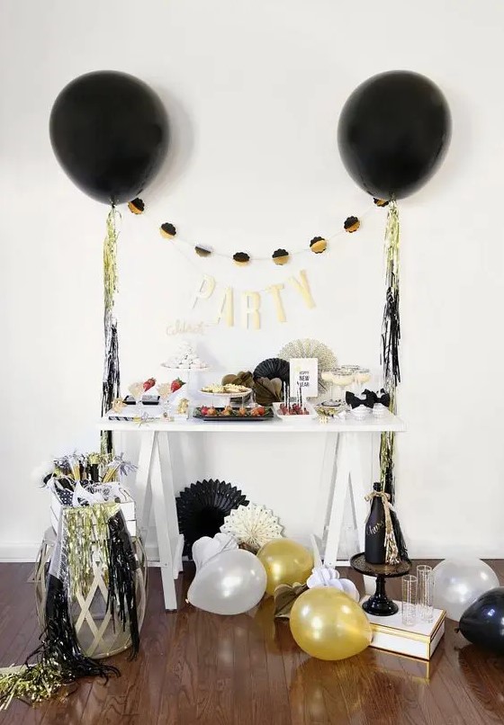 colorful fringe and black, gold and white balloons around will make any space party-like