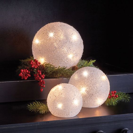 large snowball Christmas lights with berries and fir branches is a creative and cute decor idea for holidays